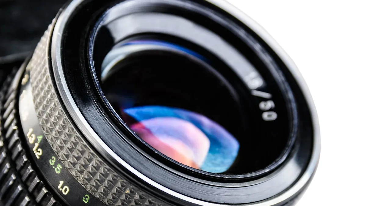A close-up view of a camera lens, with the lens's aperture and focal length markings visible.
